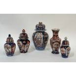 A group of Imari porcelain comprising four lidded jars variously decorated in cobalt blue and red/