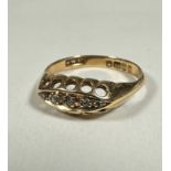 An Edwardian 18ct gold ring set with central oval panel, set five rose cut diamond chips enclosed in
