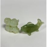 A Chinese carved celadon jadeite tumbling boy figure group with pierced central hole, (3.5cm) and