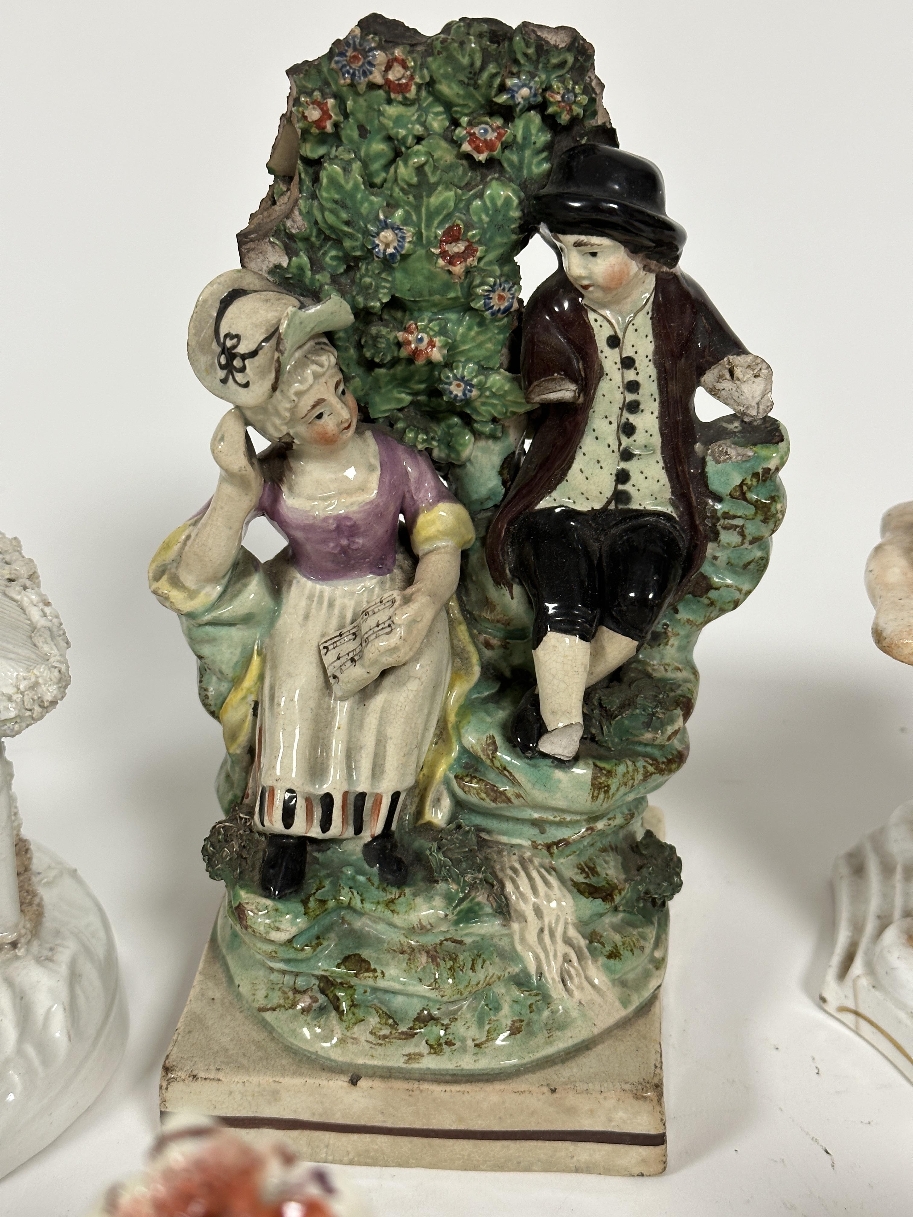 An early 19thc Pratt ware figure group of a courting couple, back a/f, lady holding a sheet of - Image 2 of 7