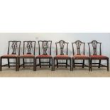 A harlequin set of seven (4, 2, 1) Georgian mahogany dining chairs, each with red suede