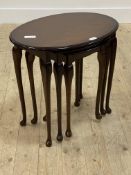 A reproduction mahogany nest of three tables with oval tops on cabriole supports H56cm W52cm