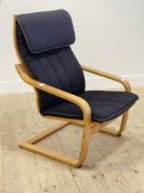 An Ikea Poang lounge chair, bent wood laminated frame supporting an upholstered seat cushion H101cm,