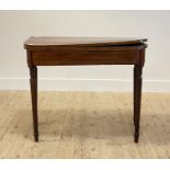 An early 19th century mahogany card table, the fold over revolving top opening to a baize lined