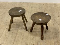 An early 20th century varnished walnut stool, the dished top with floral design raised on turned