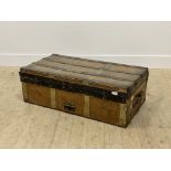 An early 20th century tooled leather and wooden bound steamer trunk, with leather carry handle to