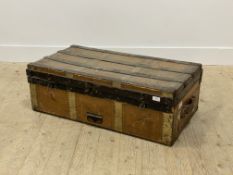 An early 20th century tooled leather and wooden bound steamer trunk, with leather carry handle to