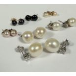 A pair of large cultured pearl oval pearl stud earrings with paste mounted posts and a pair of