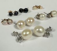 A pair of large cultured pearl oval pearl stud earrings with paste mounted posts and a pair of