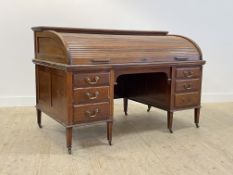 Waring and Gillow, an impressive early 20th century mahogany and walnut roll top desk, the tambour