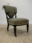 An Aesthetic period ebonised chair, upholstered in green damask, raised on turned supports and