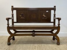 An oak hall bench, early 20th century, the three panel back carved with hunting horn and a dove with