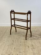 An Edwardian walnut towel rail, with six rungs raised on boxwood strung square splayed supports,