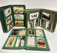 Three late Victorian/early Edwardian postcard albums containing a large collection of humorous