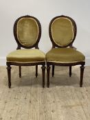 A pair of 19thc walnut side chairs, the oval back with spiral moulded show frame, over upholstered