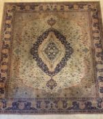 A Persian style machine woven carpet, mid 20th century, the ivory field with blue medallion and