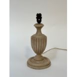 An art deco wooden urn shaped table lamp on circular raised base. (h- 34)