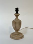 An art deco wooden urn shaped table lamp on circular raised base. (h- 34)