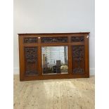 A late Victorian oak over mantel mirror, the frame with six panels each carve with fruit and