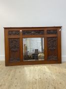 A late Victorian oak over mantel mirror, the frame with six panels each carve with fruit and