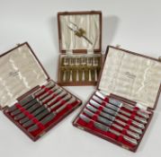 Two boxes containing six Sheffield silver handled tea knives, retailed by Harrods, London, in