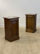 A pair of Edwardian mahogany bedside cupboards, the variegated rouge marble tops over fielded