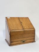 A Victorian oak stationary casket, the interior surmounted by a perpetual calendar and fitted in the