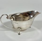 A Birmingham, 1929, George III style scalloped sauce boat, with C scroll handles to side and cast
