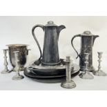 A group of pewter items comprising a Champagne bucket with scallop shell handles, four platters (