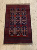A new Baluchi rug, the red field with gul motif, 133cm x 86cm