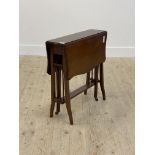 An Edwardian mahogany Sutherland table, the top of serpentine outline raised on square tapered and