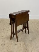 An Edwardian mahogany Sutherland table, the top of serpentine outline raised on square tapered and