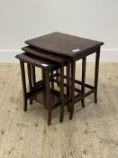 A reproduction mahogany next of three tables, the moulded tops raised on square tapered and