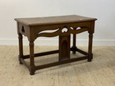 A late 19th century Gothic revival oak console table, with pierce carved frieze, raised on ring