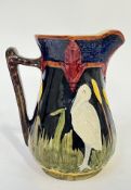 A Shorter and Sons majolica heron jug with decoration modelled in low relief and glazed in bright
