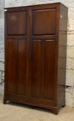 An Edwardian mahogany School cupboard, the twin panelled doors enclosing an interior fitted for
