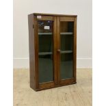 An Edwardian bleeched mahogany wall hanging cabinet, two glazed doors enclosing two shelves H67cm,