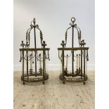 A pair of large brass hall lanterns of cylindrical outline in the Neoclassical taste, early 20th