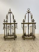 A pair of large brass hall lanterns of cylindrical outline in the Neoclassical taste, early 20th