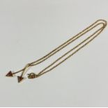 A twin arrow pendant set pale pink stones, in open work triangular claw mounted setting, on 9ct gold