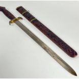 An Eastern teak carved handled sword, complete with carved scabbard, with brass mounts depicting