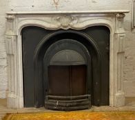 A French Louis XVI style white marble fire place, serpentine mantel piece over acanthus carved