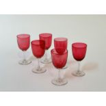 A set of six Edwardian cranberry clear cut glass wine glasses. (h- 13cm) (6)