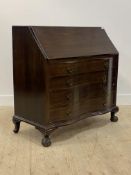 A 20th century mahogany bureau, the fall front revealing fitted interior, over four serpentine