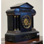 A Victorian slate mantel clock of Palladian form, with cast brass frieze, plain fluted columns on