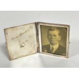 A sterling silver fold open travelling photograph frame with Andros K Lisa stamped sterling, catch