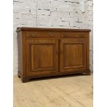 An Edwardian walnut sideboard, the ledge back over two drawers and two panelled cupboards, raised on