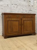 An Edwardian walnut sideboard, the ledge back over two drawers and two panelled cupboards, raised on