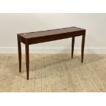 A cherry wood console table by Grange, the panelled top over three frieze drawers, raised on