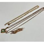 An Edwardian 9ct gold bar brooch with central scroll set nine graduated half seed pearls mounted